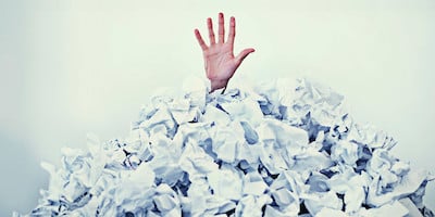 Hand Sticking Out of Pile of Paperwork