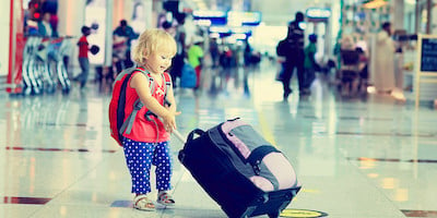 Toddler Pulling Baggage in Airport Terminal