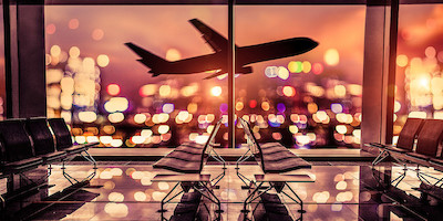 Empty Airport with Plane Taking Off at Night