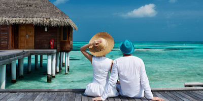 Older Couples Sitting on Tropical Boardwalk Overlooking Water