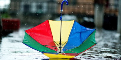 Upside Down Colorful Umbrella on Cobblestone Street