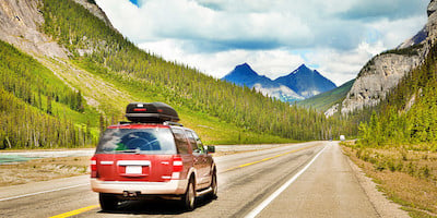 SUV Driving to the Mountains in the Distance